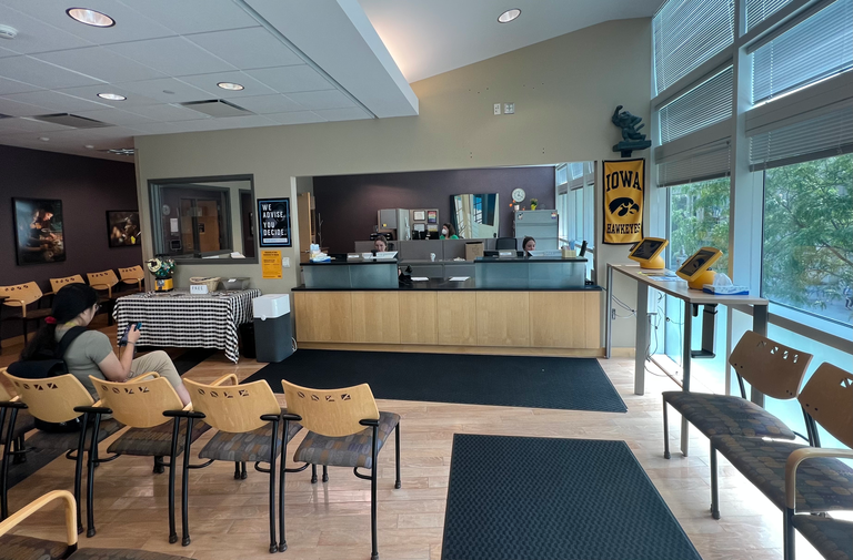 The reception area of the Academic Advising Center, with student check in and seating.